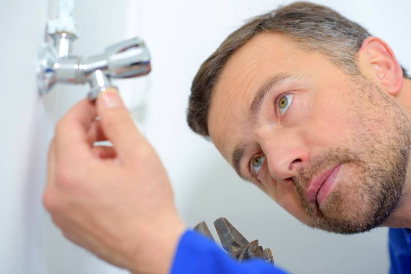man fixing the shower head