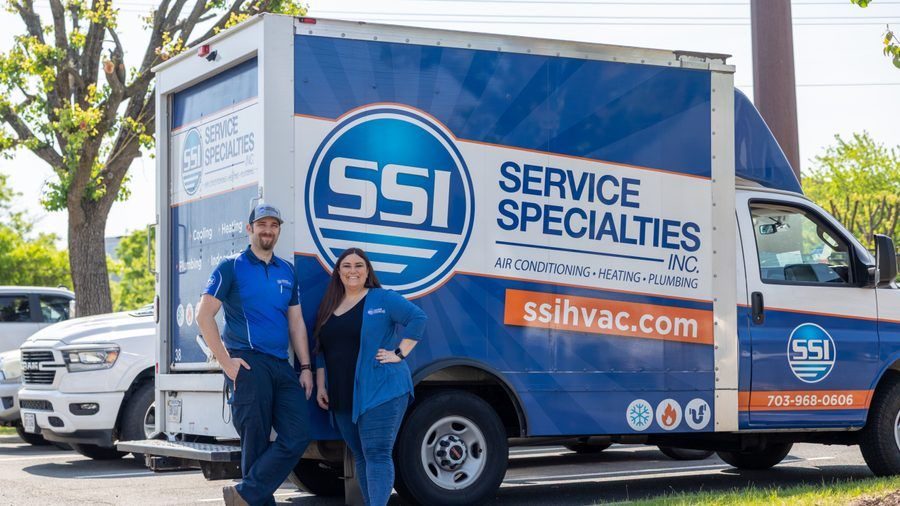 Service Specialties employees posing in front of company van.