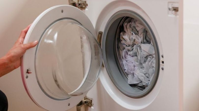 Freshly washed laundry in washing machine using softened water